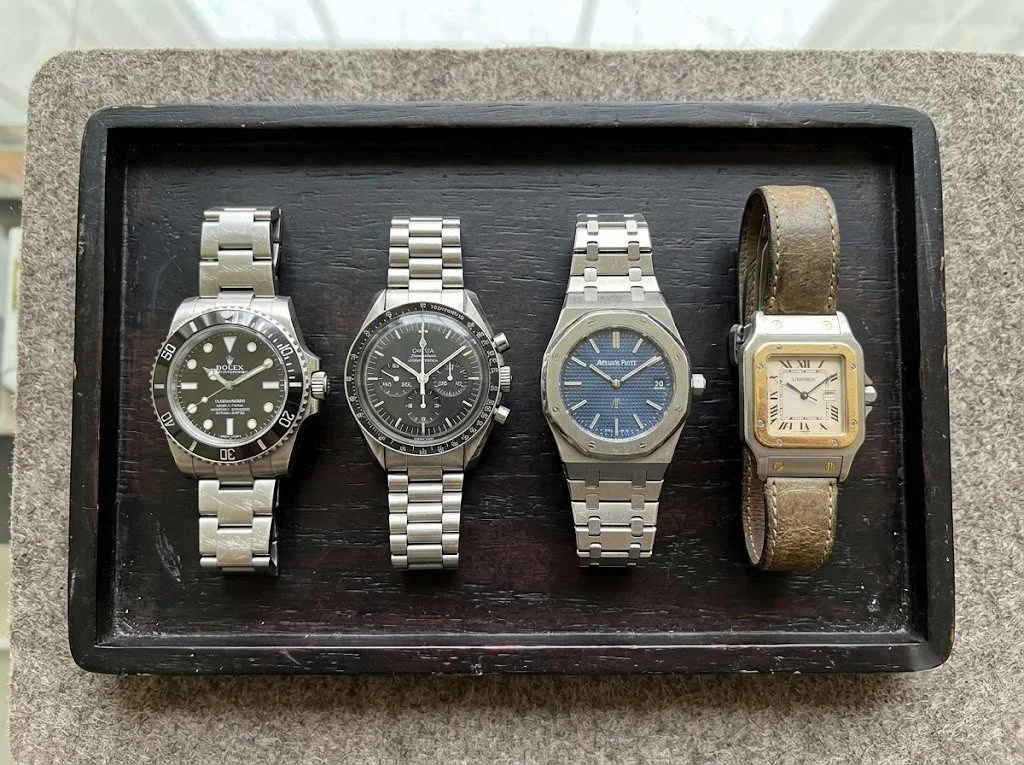 Rolex, Omega and Audemars Piguet watches displayed together 